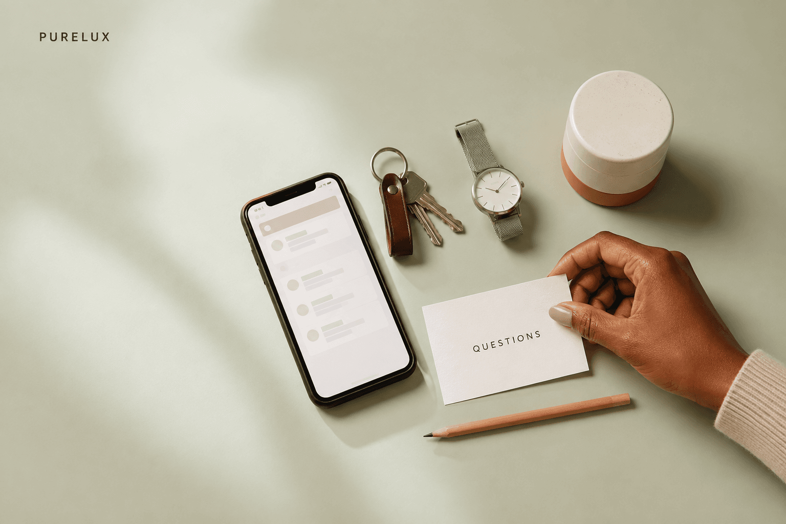 A phone, keys, watch, and question card arranged before a spa appointment